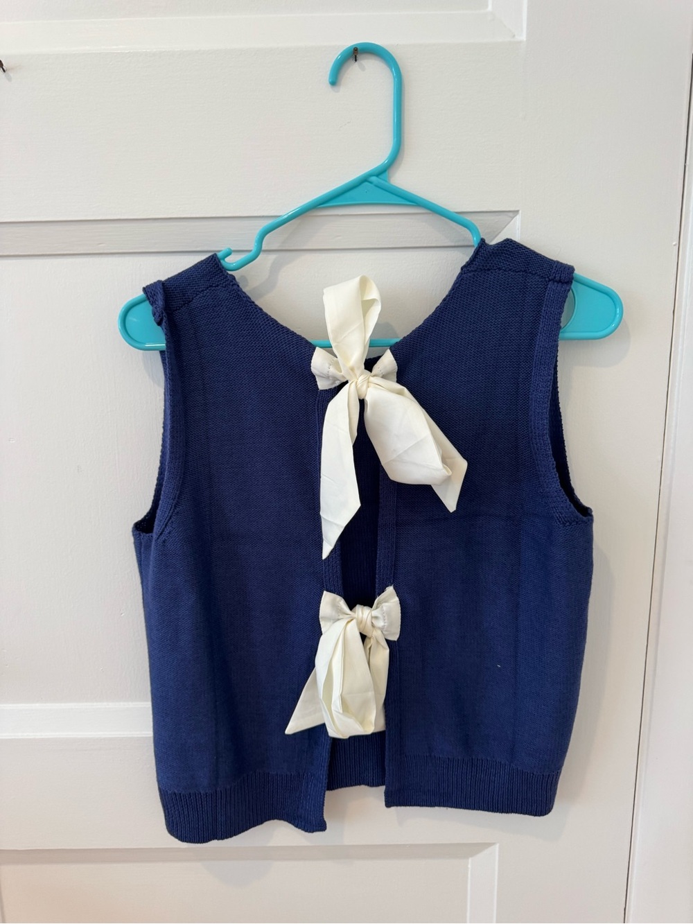 Navy Knit Sleeveless Cardigan with Ivory Bow Ties